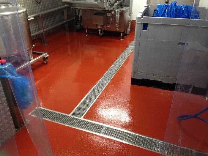 Cementitious urethane flooring in food processing facility with wet washdown environment