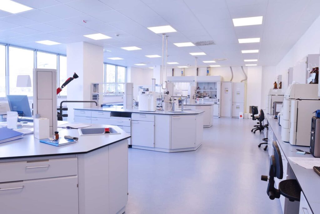 Engineer testing ESD flooring resistance in electronics manufacturing facility