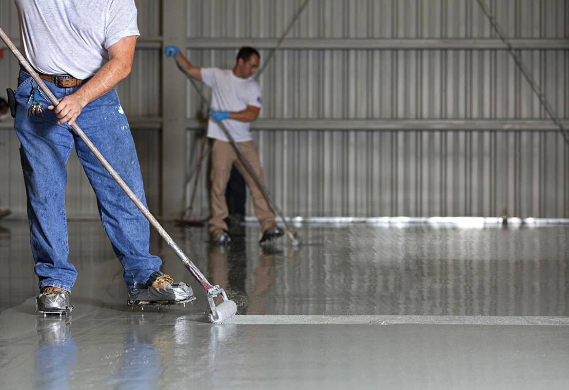 Seamless industrial resin flooring in warehouse facility with forklifts