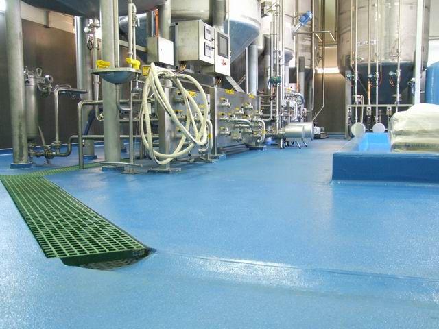 Chemical-resistant epoxy flooring in an industrial manufacturing facility.