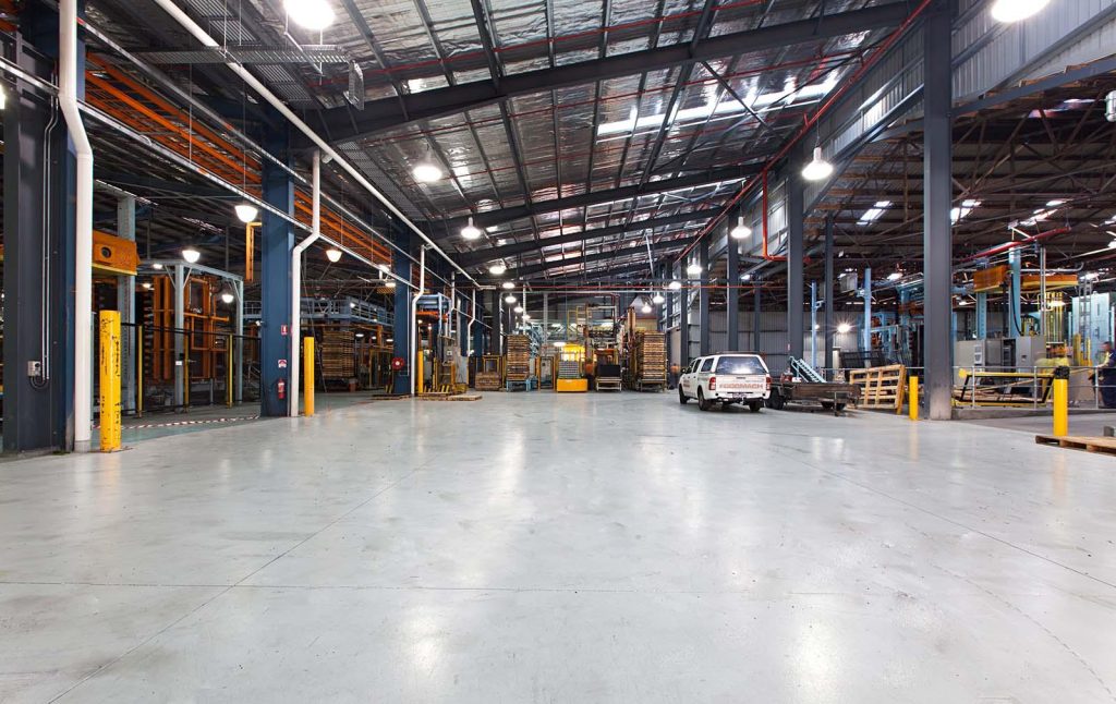 Industrial warehouse floor with forklift and concrete flooring